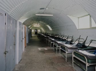 Interior view of R & F accommodation hut (hut 80) showing  line of beds with lockers