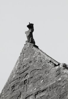 Damaged roof-finial (carved in the form of a unicorn) on gable-end of S burial-aisle.