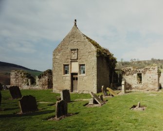 View of church from SE, showing gable-end of S burial-aisle, with armorial panel and roof-finial.