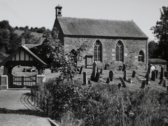 General view of gate and church, from SW