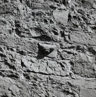 Damaged masonry fragment, built into central portion of exterior S wall of church