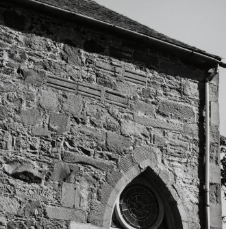 Re-used masonry fragments, built into exterior of S wall of church, near E end