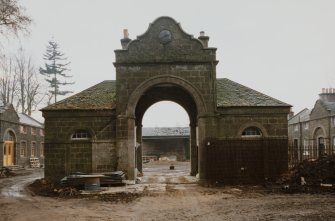 View of gatehouse and archway into courtyard from E