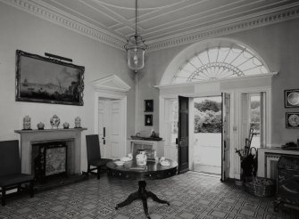 Interior.View of entrance hall from NW showing fireplace and entrance door