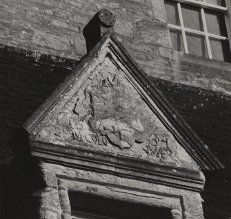 Detail of inscribed pediment of dormer window at old house.
