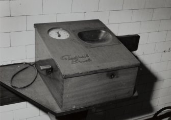 Perth, Glover Street Works, Messrs. Dewar Distillery, interior.
North office block, detail of "Gledhill Brook" clocking on machine in Welfare room.