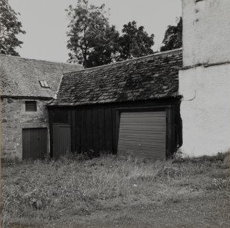 View of timber garage to West of mill from North-West.