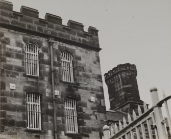 Perth, Edinburgh Road, Perth Prison.
General view of South wing, crenellated parapet and drainpipe with 1876 date.