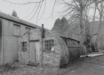 Garages/Workshops and nissen hut. View from ESE