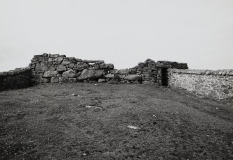 View of surviving West wall, taken from East, at Dun Briste site on Isle of Berneray.