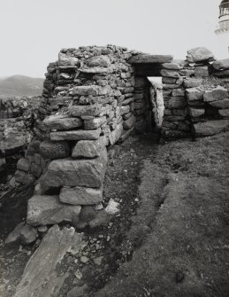 View, from West, of surviving doorway in ruined wall at Dun Briste site, Isle of Berneray.