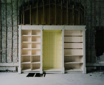 Interior. Ground floor, library, view of bookcase on N wall