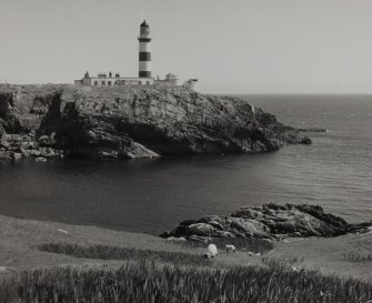 General view from W of lighthouse complex, showing rocky promontory on which it is located