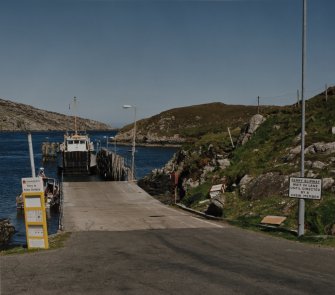 View from WSW of ramp and Isle of Rhum ferry moored at the Scalpay side, prior to moving into position to receive cars and foot passengers