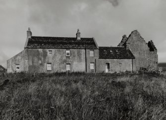 House and ruinous castle, view from South West.