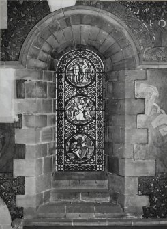 Interior. North chapel, stained glass window on north wall showing scenes from the lives of the Saints.