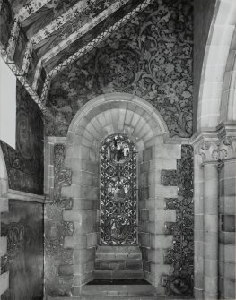 Interior. North chapel, view of mural on east wall and stained glass window.