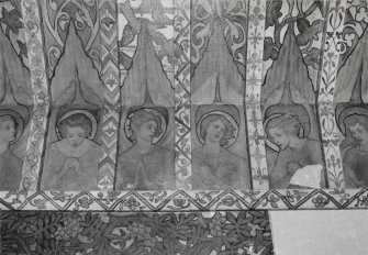 Interior. North chapel, detail of mural frieze depicting heads of angels.