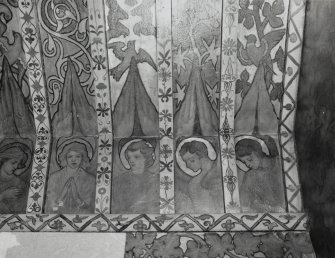 Interior. North chapel, detail of mural frieze depicting heads of angels.