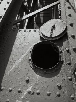 Detail of the wooden hatch cover over the access ladder in a tubular steel member on the North cantilever of the Fife erection.