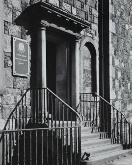 View of the main entrance with two Doric columns supporting a lintel, seen from the South West. There is a plaque beside the doorway insc. 'University of Edinburgh Clinical Surgery, Orthopaedic Surgery, Medicine.'