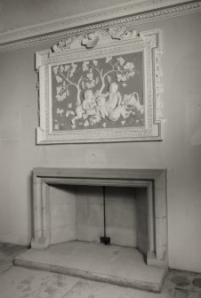 Edinburgh, 87 Giles Street, The Black Vaults, interior.
View of The Vintner's Room fireplace, of simple stonework, with a very elaborate plaster scene above depicting putti eating grapes beneath trees, framed with a Greek key design and further shells and grapes.