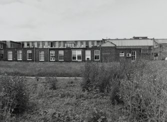 View from E of E side of main two-storeyed block of works, with single-storeyed admin block in foreground