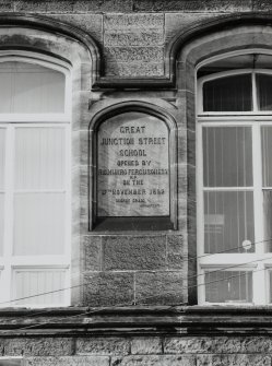 Detail of panel on NE wall of rear block with inscription "GREAT JUNCTION STREET SCHOOL Opened By R.C. Munro Ferguson Esqr. M.P. on the 17th November 1892. George Craig, Architect"