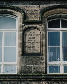 Detail of panel on NE wall of rear block with inscription "GREAT JUNCTION STREET SCHOOL Opened By R.C. Munro Ferguson Esqr. M.P. on the 17th November 1892. George Craig, Architect"