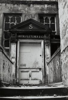 Detail of North door with sign "Smith Fletcher & Co" above