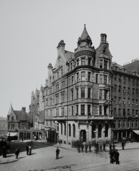 General view of bank at junction of High Street and Cockburn Street with policemen standing in middle of High Street