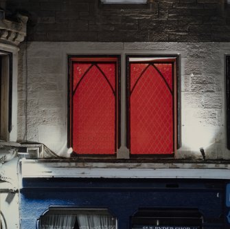 Detail of windows in upper storey of Nos 97 and 99 showing Lux Europea installation-one of 24 red perspex panels in windows-'Spostamenti sulla banda del rosso' by Vittorio Messina