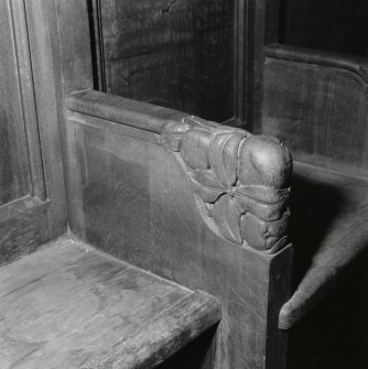 Interior, detail of platform woodwork showing apple branch armrest