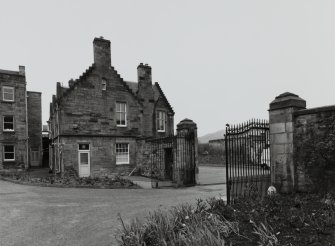View of lodge and gates from W