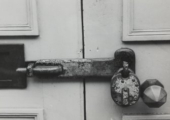 Detail of bar commonly used for securing a door from outside