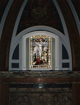 Interior, detail of central stained glass window in chancel