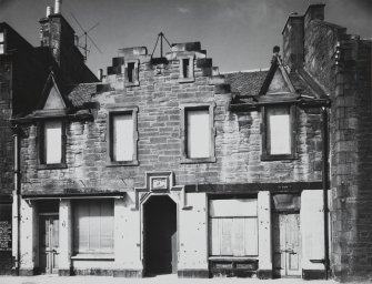 Newhaven, Fishermen's Hall, 56-58 Main Street, and 12 Pier Place.
View from South of four bay main elevation prior to restoration, showing crow-stepped gables, flower-motif finials and stepped hood mould over Main Street entrance.