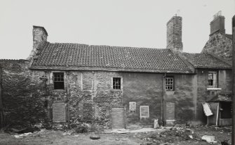 Bonnington Mills Cottages.
View of part harled part limewashed South elevation, showing blocked openings.