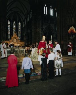 Interior.
View of crossing area and apse ended chancel showing bishop receiving children for Confirmation.