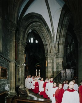 Interior.
View of aisle showing choiristers' procession passing by crossing area.