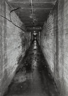 Edinburgh, Leith Walk, Shrub place, Shrubhill Tramway Workshops and Power Station
Interior view from south east within tunnel leading from the former Tramway Power Station.  The tunnel carried the moving cables towards Leith Walk.  This view is looking back from the blocked end of the tunnel towards the Power Station, and was accessed from the Storage area in the basement.