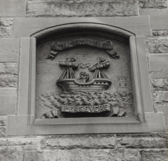 Edinburgh, Leith, 23-24 Sandport Place.
Detail of West panel on North facade, a sailing ship with two inscribed ribbons.
Insc: 'SICILLUMOPPIDIDELEITH' and 'Persevere'.