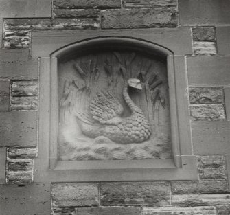 Edinburgh, Leith, 23-24 Sandport Place.
Detail of East panel on North facade, a swan swimming among tall bulrushes.