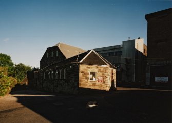 View from SW of gatehouse and offices (foreground), former maltings block (background centre) with new steel-clad block for Saladin boxes, and new whisky bond (right)