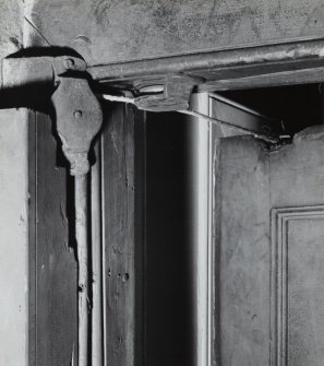 Interior, upper ground floor, view of rear apartment door-closing mechanism.