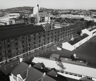 Elevated view from south east (on floodlight tower of Tynecastle Stadium) of range containing Duty Free Warehouses Nos. 5, 6 and 7 (6 roofless), and in background, Still House.