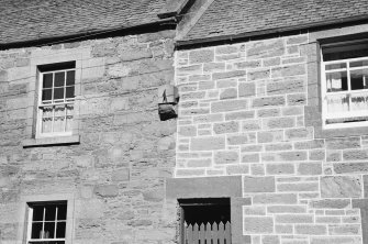 View of sundial in wall of houses on north side of Drummond Street, Muthill.