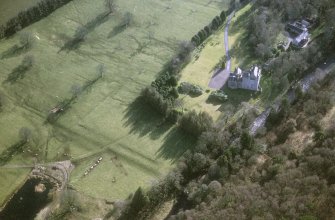 Oblique aerial view centred on the tower-house with the stables adjacent, taken from the N.