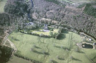 Oblique aerial view centred on the tower-house with the stables and kennels adjacent, taken from the SE.