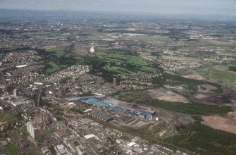 General oblique aerial view looking across the Steelworks towards Airdrie, taken from the S.